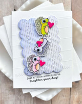 Handmade greeting card with hedgehogs on it with hearts and just a little something to brighten your day sentiment on it.