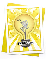 Handmade greeting card with light bulb on it and push button with shine bright sentiment on it.