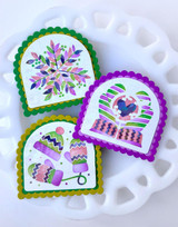 Three handmade greeting tags with winter hats, mittens, and snowflakes on them.
