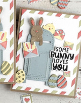 Handmade greeting card with springtime items on it and a bunny in a mailbox with some bunny loves you sentiment on it.