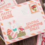 Handmade greeting card with springtime postage on it and sending springtime smiles sentiment on it.