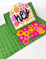 Handmade greeting card with flowers on it and hey sentiment on it.