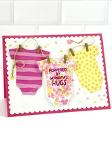 Handmade greeting card with onesies on it and powered by grandma's hugs sentiment on it.