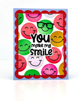 Handmade greeting card with you make me smile sentiment on it with smiley faces on it.