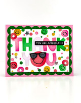 Handmade greeting card with smiley faces on it and smiley faces on it and thank you sentiment on it.