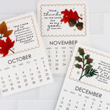 Three handmade calendars with leaves and bible verses on each.