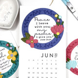 Three handmade calendars with bible verses inside a leaf wreath.