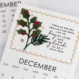 Handmade calendar with a bible verse on it and leaves on it.