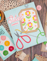 Handmade greeting card with embroidery hoop on it and stitch happens sentiment on it.