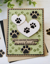Handmade greeting card with hearts on it and love leaves pawprints in our hearts sentiment on it.