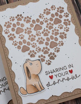 Handmade greeting card with pawprints on it and sharing in your sorrow sentiment on it.