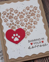 Handmade greeting card with pawprints and hearts on. it and sharing in your sorrow sentiment on it.