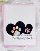 Handmade greeting card with paw prints on it and hearts with in memory of a faithful friend sentiment on it.