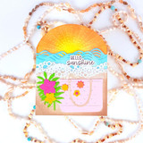 Handmade greeting card with beach themed items on it and hello sunshine sentiment on it.