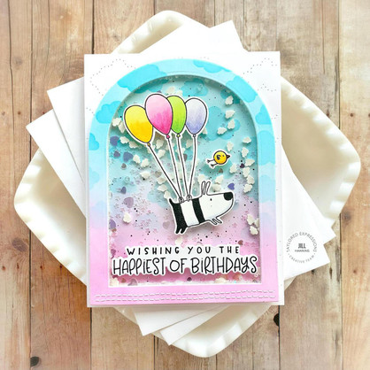 Handmade greeting card with a dog and bird on it with balloons and wishing you the happiest of birthdays sentiment on it.