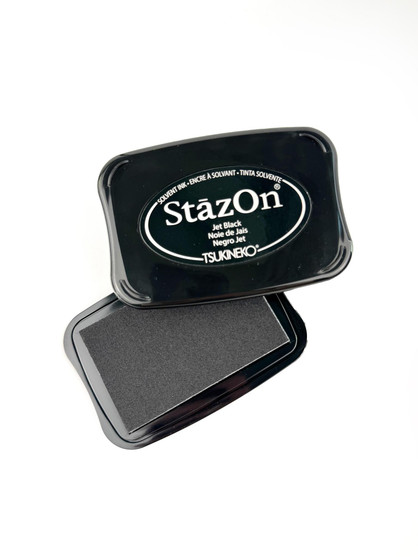 Image of Stazon Solvent Ink - Jet Black that is opened up to show the ink, used for papercrafting. Image of Stazon Solvent Ink - Jet Black that is opened up to show the ink, used for papercrafting.
