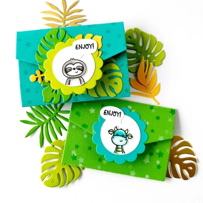 Two handmade gift card wallets with magical creatures on each.