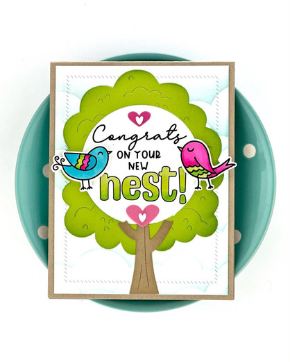 Handmade greeting card with doodle birds on a tree with congrats on your new nest sentiment with bowl in background.