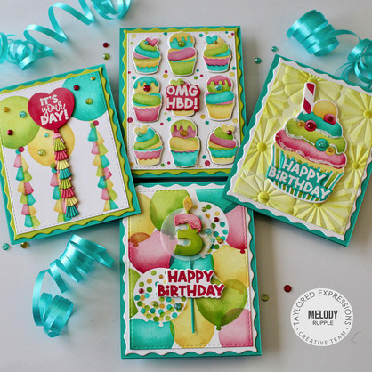 Four handmade greeting cards with cupcakes, balloons, and various happy birthday sentiments on each.
