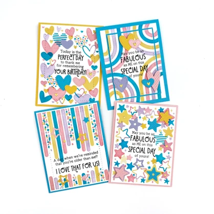 Four handmade greeting cards with different birthday sentiments on them with hearts, stars, streamers, and circles.