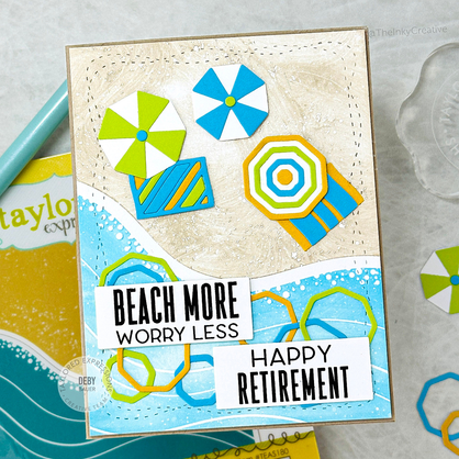 Handmade greeting card with a beach on it and beach more worry less sentiment and happy retirement sentiment on it.