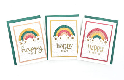 Three handmade greeting cards with two having rainbows and happy hello sentiment and one having a rainbow and happy birthday sentiment.
