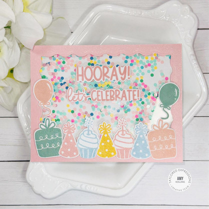 Handmade greeting card with cupcakes, party hats, and presents with hooray! let's celebrate sentiment on it with flowers in background.