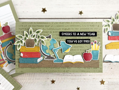 Handmade greeting card with a glob on it, a plant, classroom supplies and books with cheers to a new year, you've got this! sentiment on it.