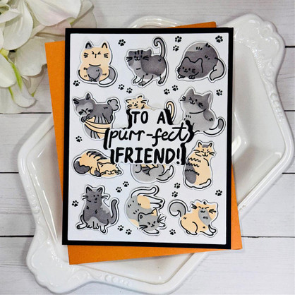 Handmade greeting card with cats on it playing with toys and to a purr-fect friend sentiment on it.