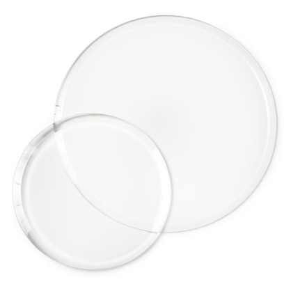 Two clear circular die cutting plates stacked and slightly overlapping. Two clear circular die cutting plates stacked and slightly overlapping.