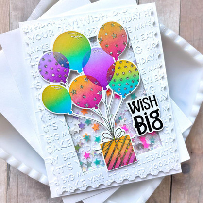 Handmade greeting card with balloons holding a present up and wish big sentiment on it.
