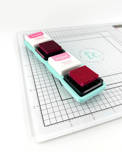 Image of Glassboard Buddy - Mini Ink Cubes which is a magnetic tray that holds mini ink pads and in the picture there is an example of two mini inks with the lids off.