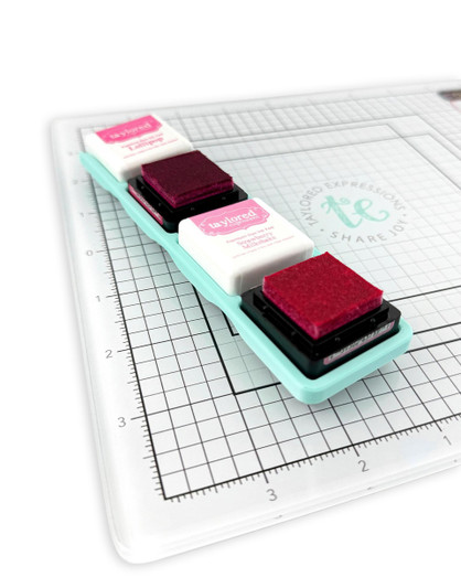 Image of Glassboard Buddy - Mini Ink Cubes which is a magnetic tray that holds mini ink pads and in the picture there is an example of two mini inks with the lids off.