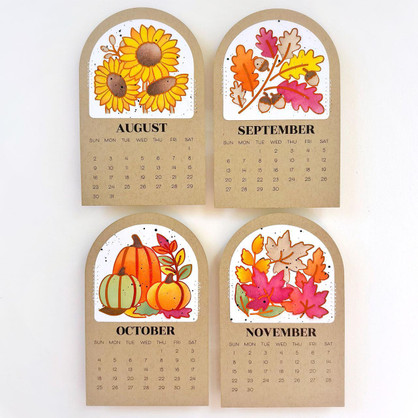 Four handmade calendars with leaves and flowers on each.