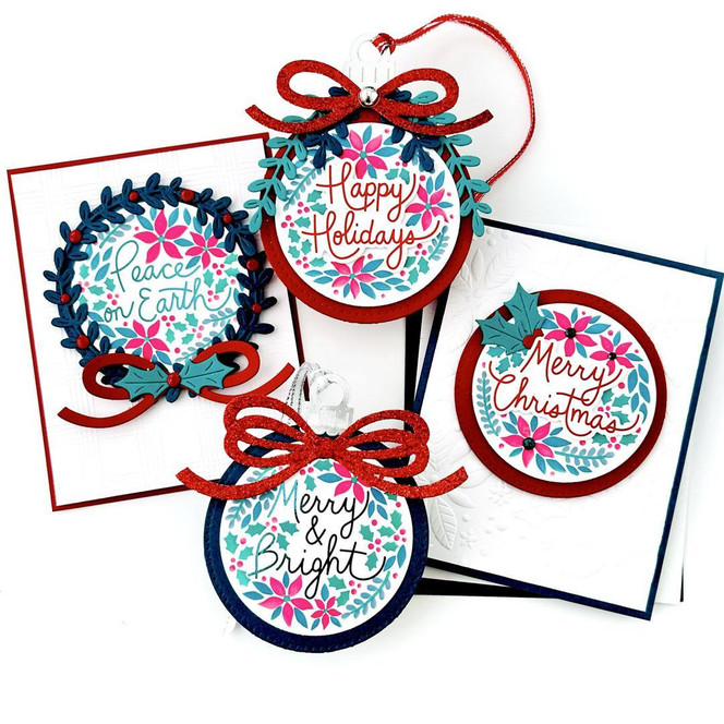Four handmade greeting cards with various ornaments on each and different Christmas sentiments on each.