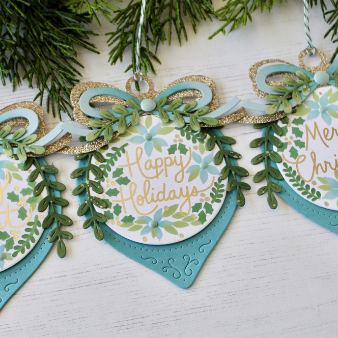 Handmade ornament with happy holidays sentiment on it.