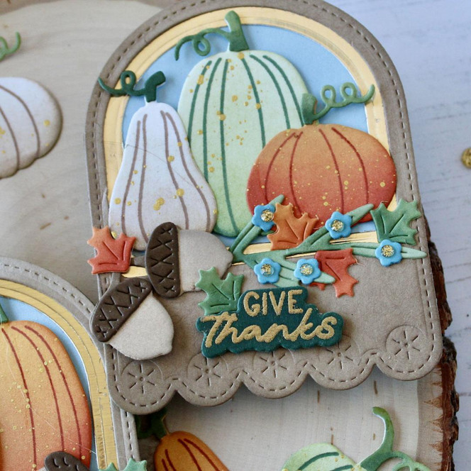 Handmade gift tag with pumpkins on it and give thanks sentiment on it.