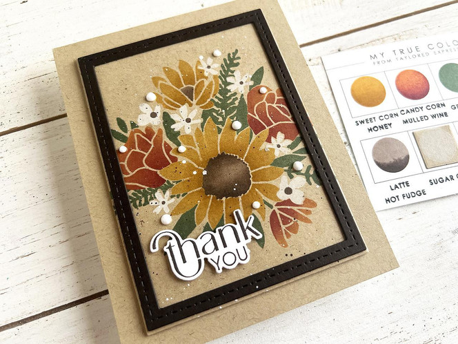Handmade greeting card with flowers on it and thank you sentiment on it.