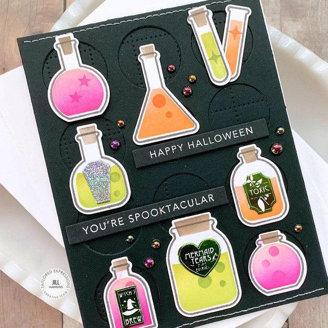 Handmade greeting card with potions on it and happy halloween, you're spooktacular sentiment on it.