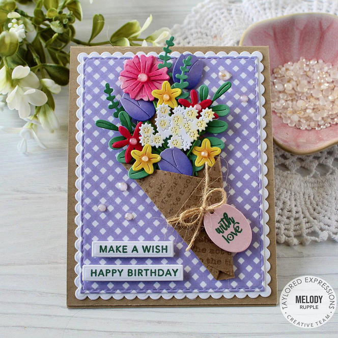 Handmade greeting card with bouquet of flowers on it with make a wish, happy birthday sentiment on it and with love sentiment on it.