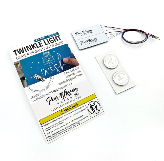 Packaging of twinkling lights and two buttons to press to light up card for paper crafting.