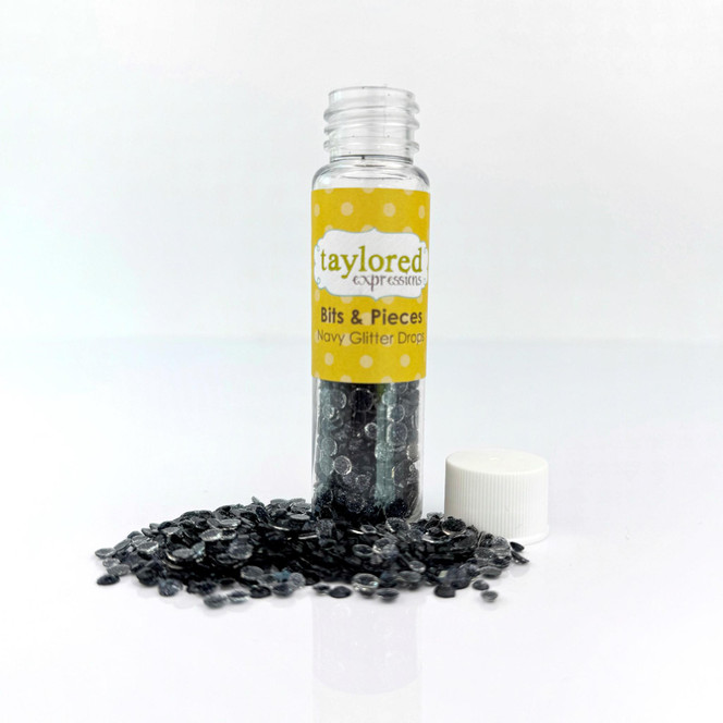 Bits & pieces of Navy Glitter Drops used for embellishment with paper crafting.