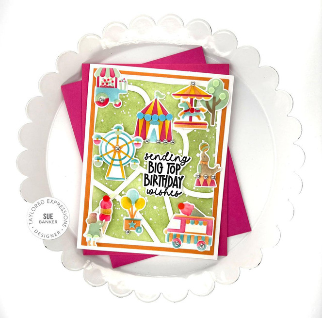 Handmade greeting card that is carnival themed with sending big top birthday wishes sentiment on it with cardstock in background.