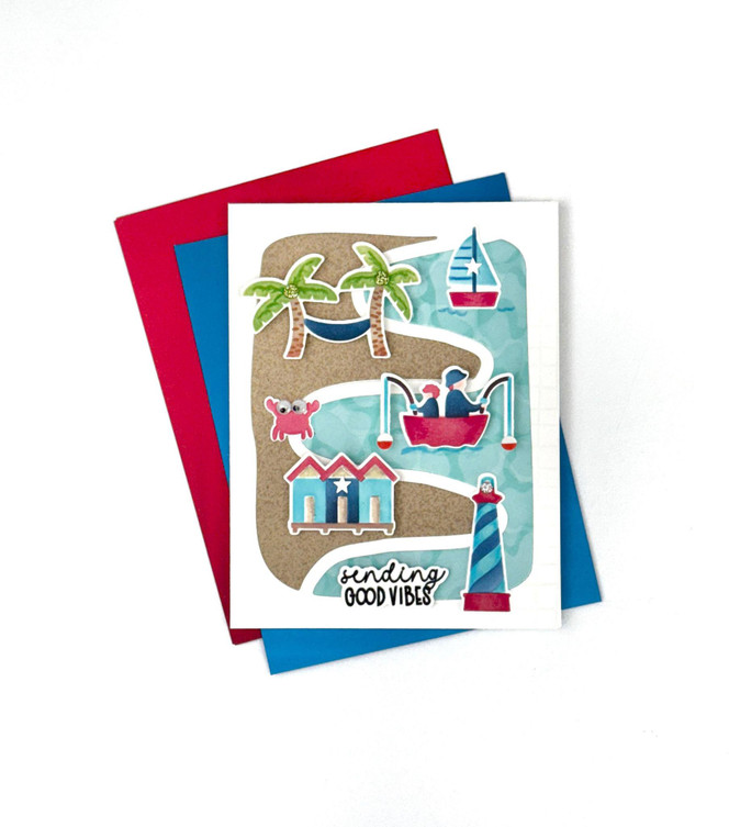 Handmade greeting card with a beach theme including a crab and sail boat with sending good vibes sentiment on it and cardstock in the background.
