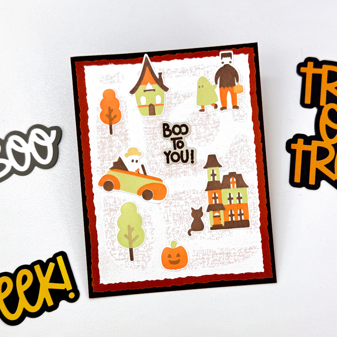 Handmade greeting card with haunted house, monsters, and pumpkins on it with boo to you sentiment on it.