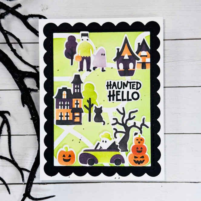 Handmade greeting card with haunted house, monsters, and pumpkins on it with haunted hello sentiment on it.