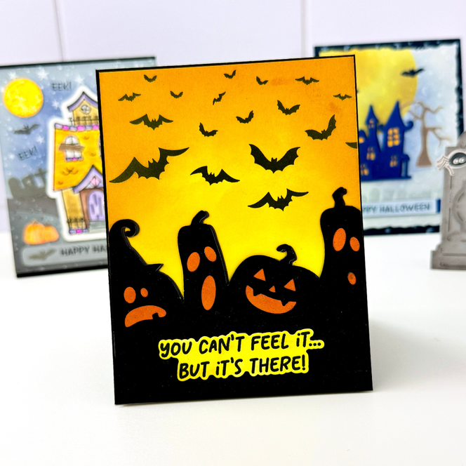 Handmade greeting card with pumpkins and bats on it with you can't feel it... but it's there sentiment on it.
