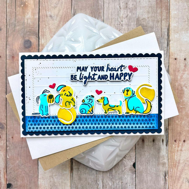 Handmade greeting card of dogs playing with toys and hearts around them with may your heart be light and happy sentiment on it.