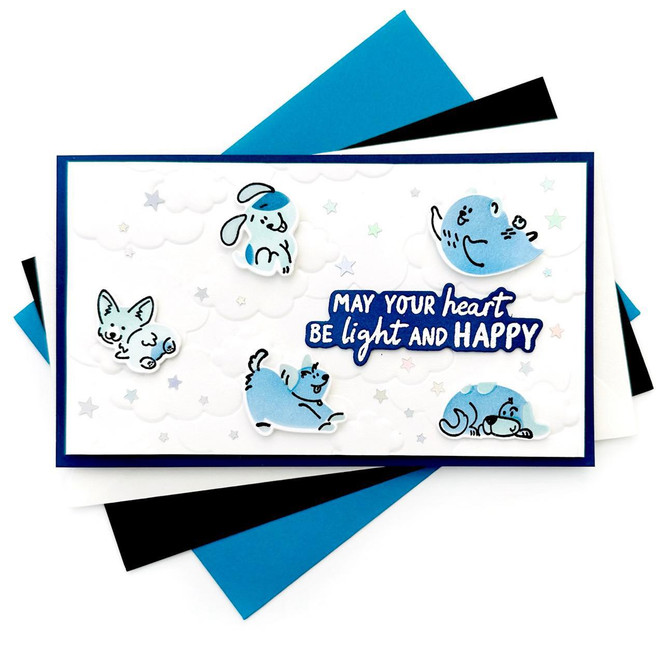 Handmade greeting card of dogs playing in the clouds with may your heart be light and happy sentiment on it.