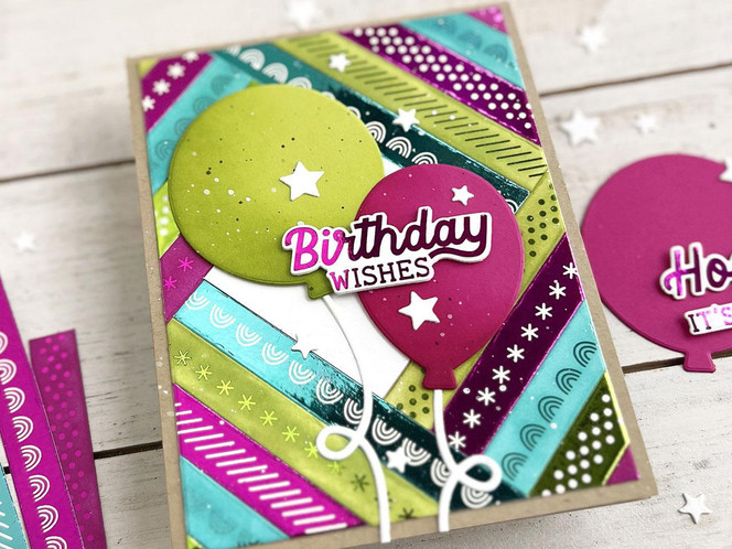 Handmade greeting card of easy strips patterns with balloons on it and birthday wishes sentiment on it.